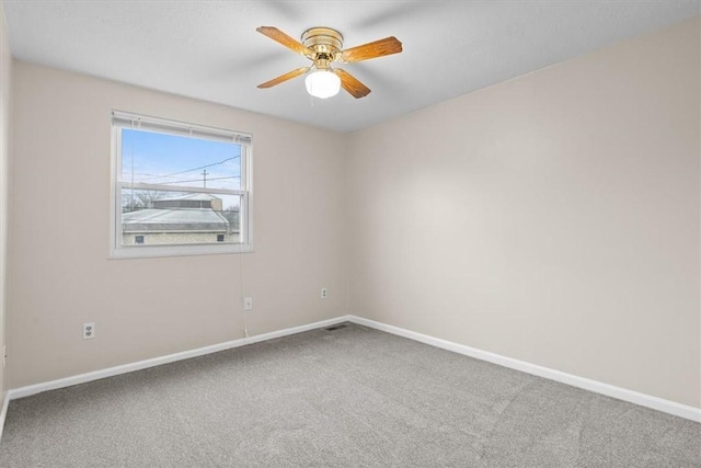 carpeted spare room with ceiling fan