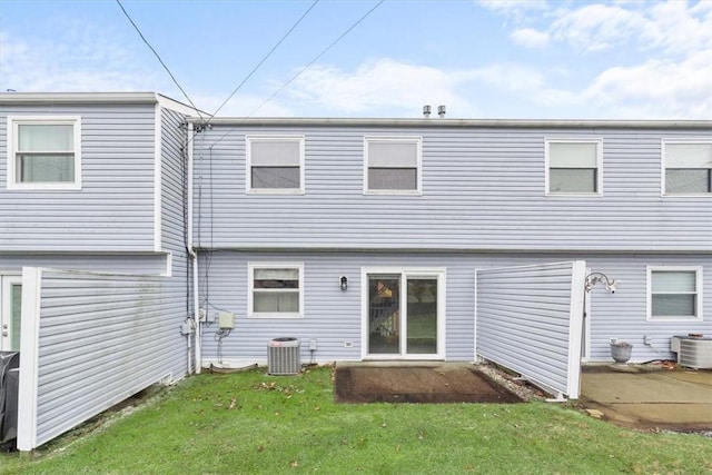 rear view of property featuring central AC, a patio, and a yard