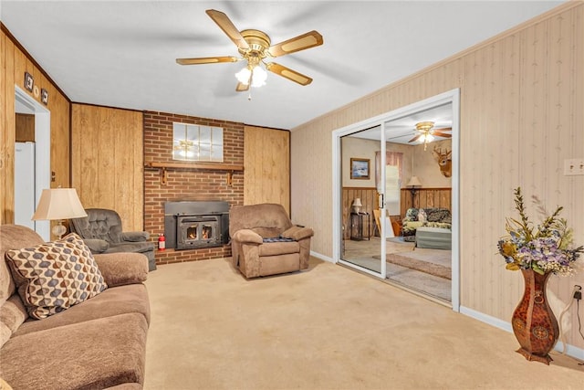 carpeted living room with a wood stove, ceiling fan, and ornamental molding