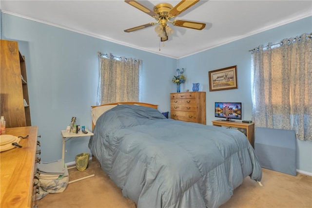 bedroom with ceiling fan, light colored carpet, and ornamental molding