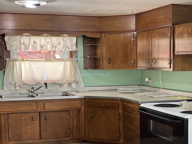 kitchen with electric stove and sink