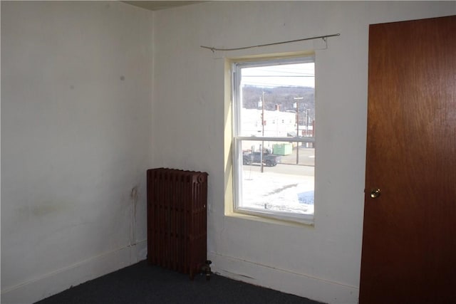 spare room featuring radiator heating unit