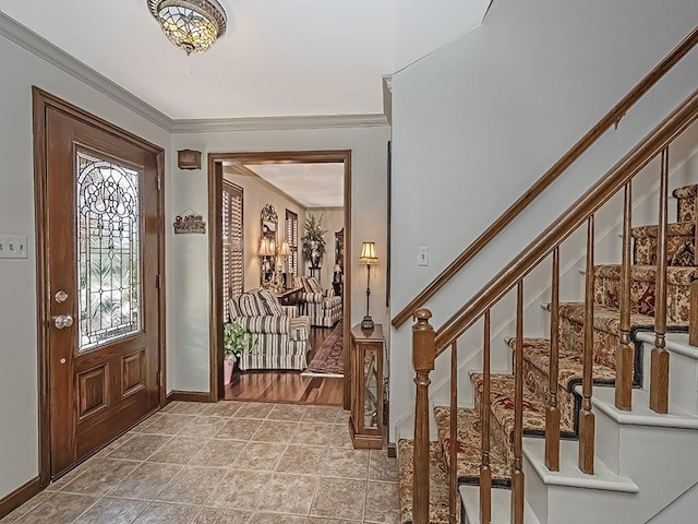 foyer with ornamental molding and light tile patterned floors