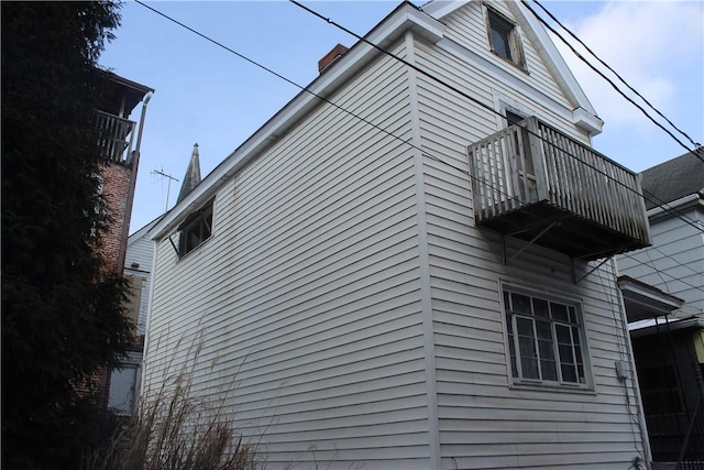 view of home's exterior with a balcony