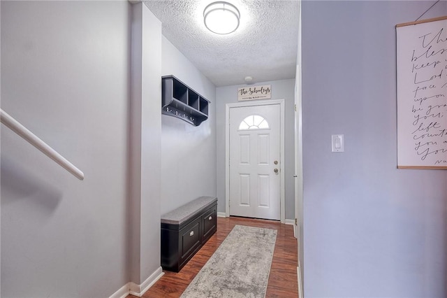 entryway with a textured ceiling and hardwood / wood-style flooring