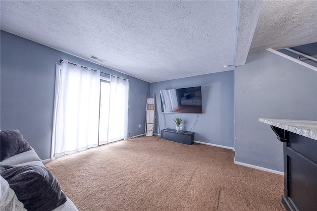 carpeted living room featuring a textured ceiling