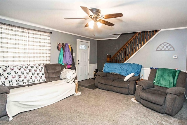 carpeted living room with ceiling fan and ornamental molding