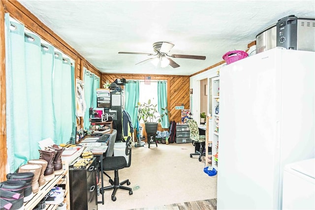 office with ceiling fan and wood walls