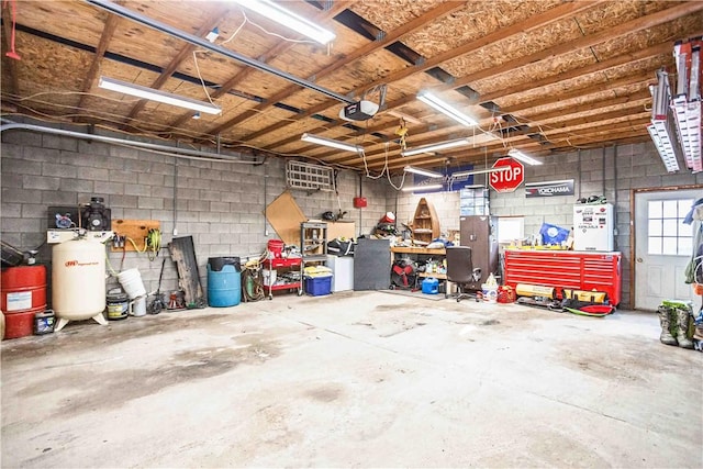 garage featuring a workshop area and a garage door opener