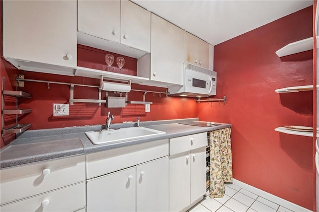 5841 Morrowfield Ave Unit 206, Squirrel Hill, PA 15217 - kitchen with white microwave, light tile patterned floors, open shelves, white cabinets, and a sink