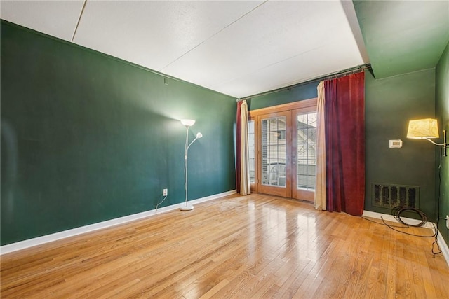 5841 Morrowfield Ave Unit 206, Squirrel Hill, PA 15217 - spare room featuring visible vents, baseboards, french doors, and wood finished floors