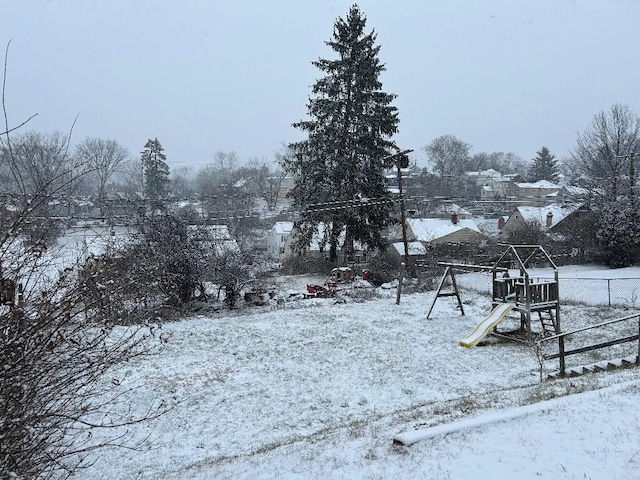 snowy yard with a playground