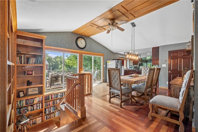 dining room with ceiling fan, lofted ceiling, and light hardwood / wood-style floors