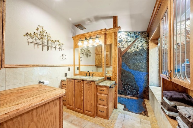 bathroom featuring tile walls, tile patterned flooring, and vanity