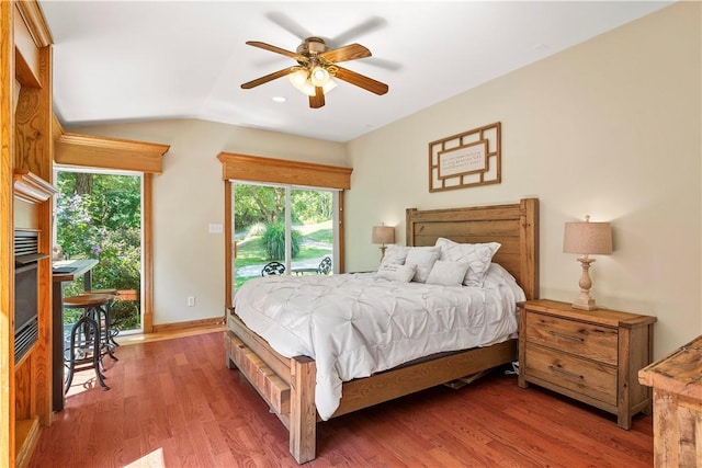 bedroom featuring ceiling fan, access to outside, dark hardwood / wood-style floors, and lofted ceiling