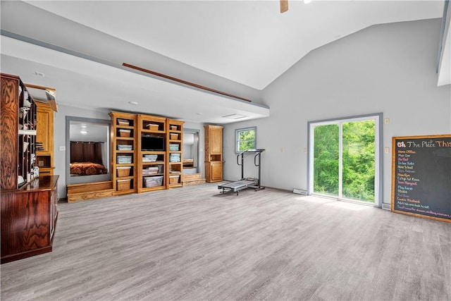 unfurnished living room with light wood-type flooring and vaulted ceiling