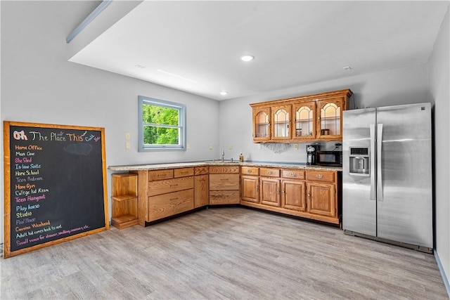 kitchen featuring light hardwood / wood-style flooring, sink, and stainless steel refrigerator with ice dispenser