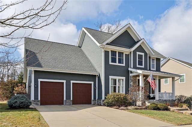 craftsman-style house featuring a porch, a garage, and a front yard