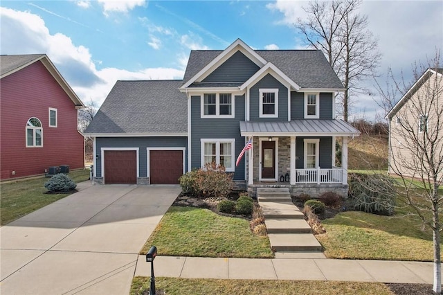 view of front of house with a front yard, a garage, and a porch