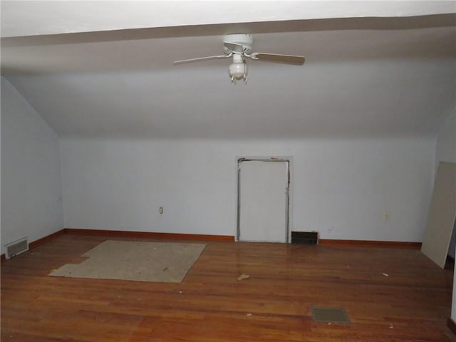 bonus room featuring dark wood-style flooring, visible vents, vaulted ceiling, ceiling fan, and baseboards