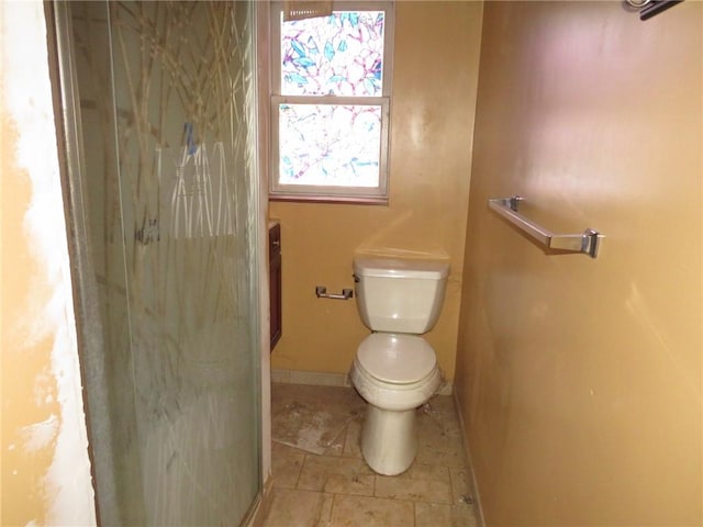 bathroom with toilet, baseboards, a shower, and tile patterned floors