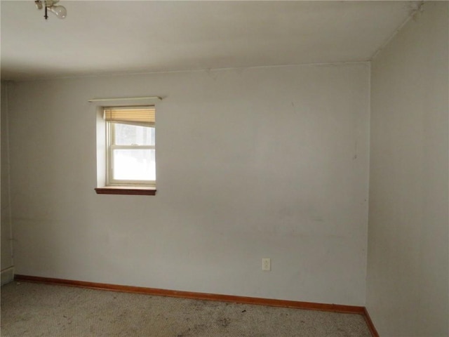 empty room with carpet and baseboards