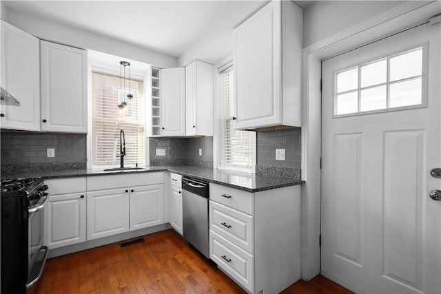 kitchen with gas stove, sink, dishwasher, dark stone counters, and white cabinets