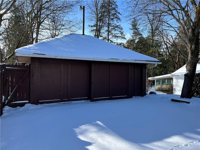 snowy yard featuring an outdoor structure