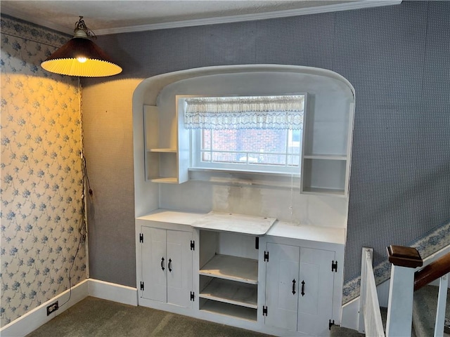 interior space with light countertops, wallpapered walls, dark carpet, and open shelves