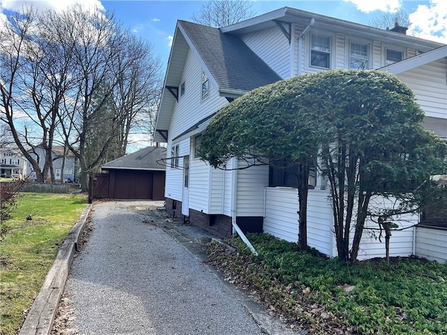 view of property exterior with a yard and fence
