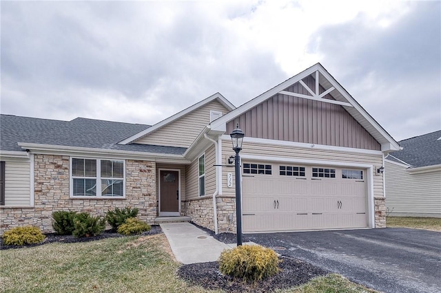 craftsman-style home featuring a front yard and a garage