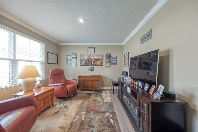 sitting room with a textured ceiling, ornamental molding, and wood-type flooring