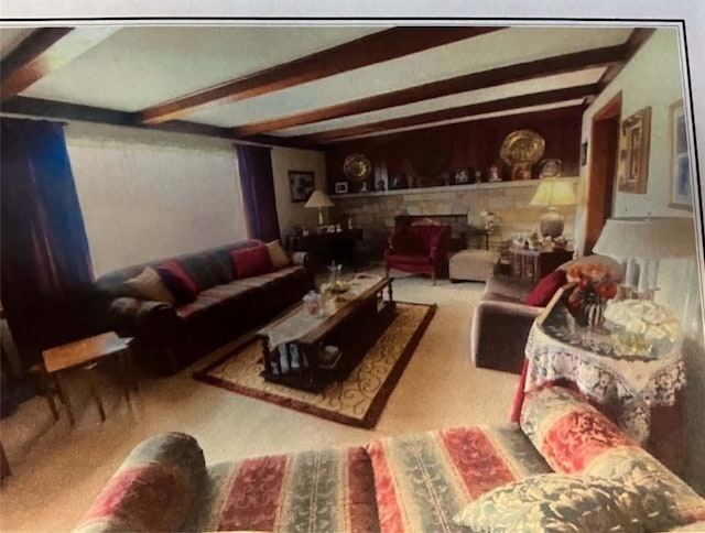 carpeted living room with beam ceiling