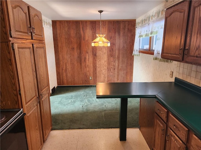 kitchen with pendant lighting, light carpet, and backsplash