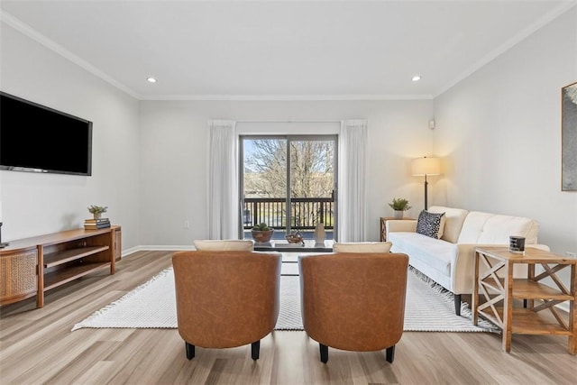 living room with light hardwood / wood-style floors and crown molding