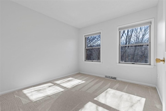 empty room featuring light carpet