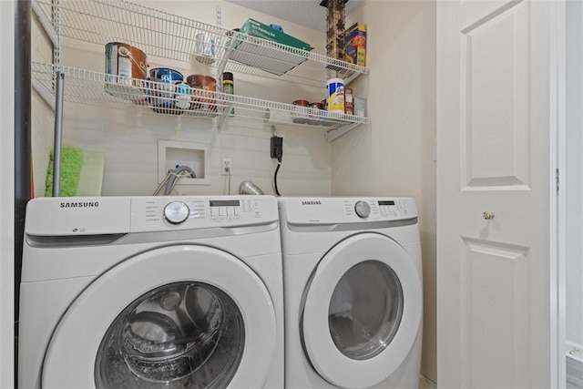 washroom with washing machine and clothes dryer