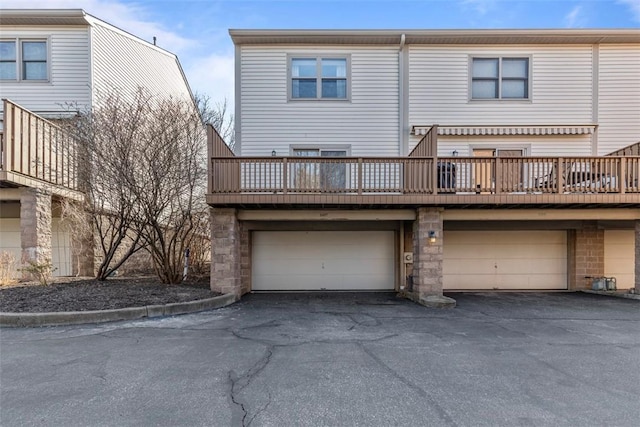 rear view of house featuring a garage