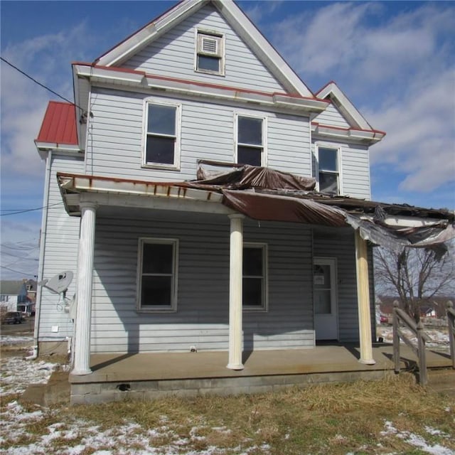 back of property with covered porch