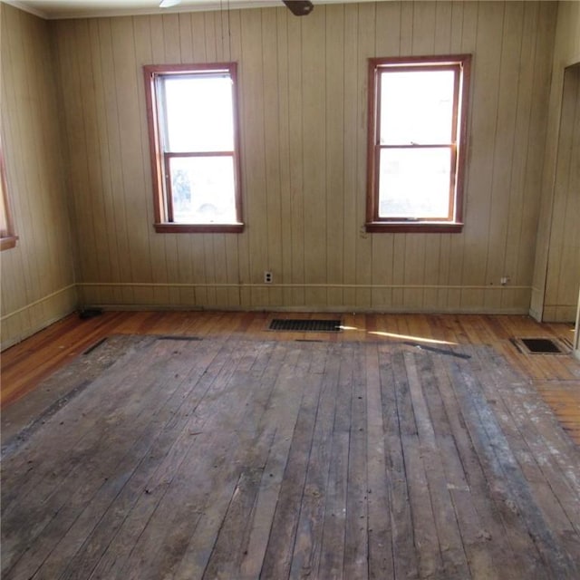 spare room with plenty of natural light and hardwood / wood-style floors