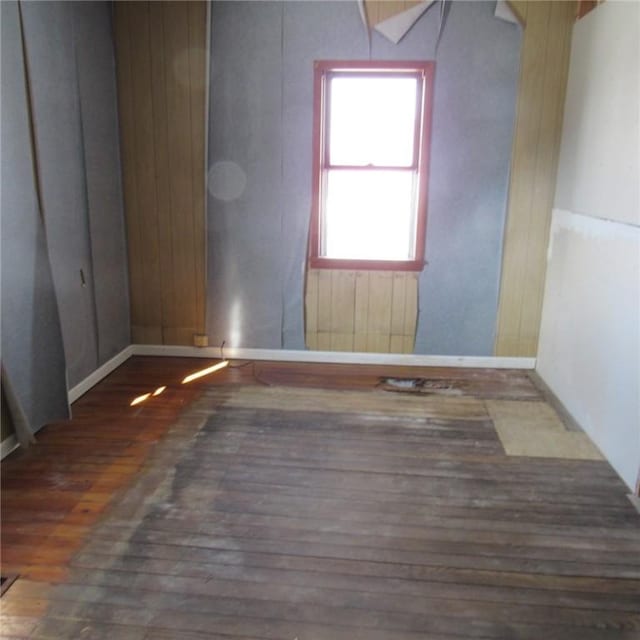 unfurnished room featuring dark hardwood / wood-style flooring