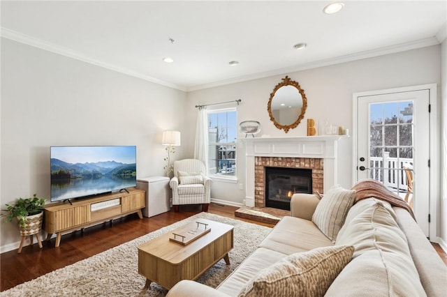 living room with dark hardwood / wood-style flooring, ornamental molding, and a brick fireplace