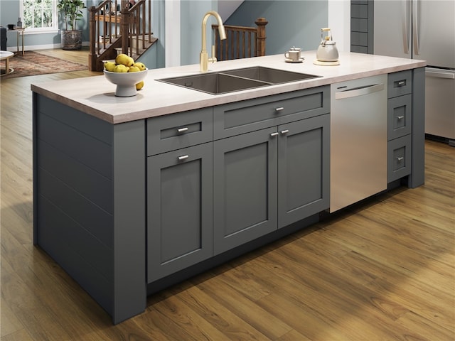 kitchen with sink, dark hardwood / wood-style floors, gray cabinetry, and stainless steel appliances