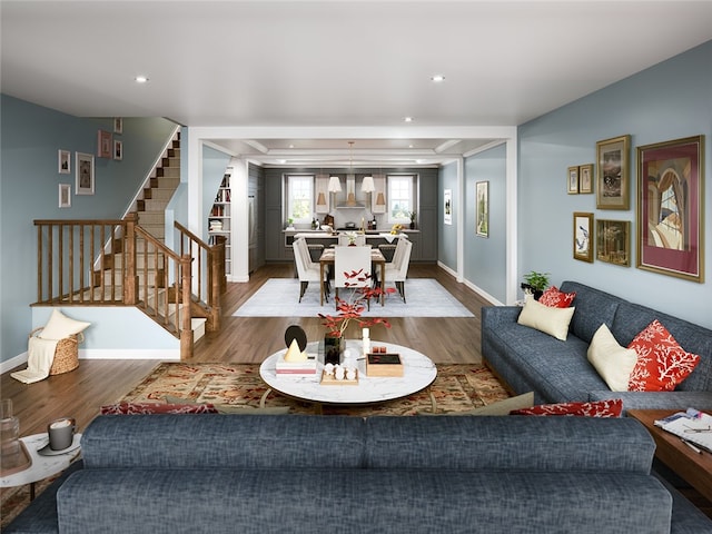 living room with a tray ceiling and hardwood / wood-style floors