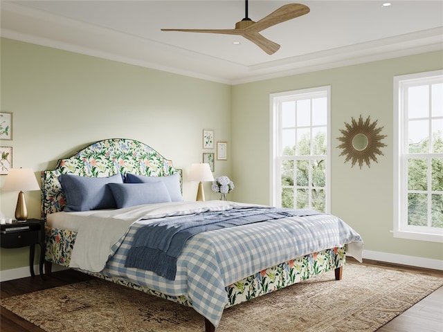 bedroom with hardwood / wood-style flooring, ceiling fan, and crown molding