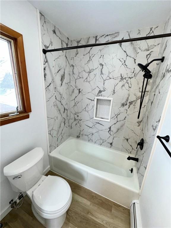 302 S Main St, Masontown, PA 15461 - full bathroom with shower / tub combination, toilet, wood finished floors, and baseboard heating