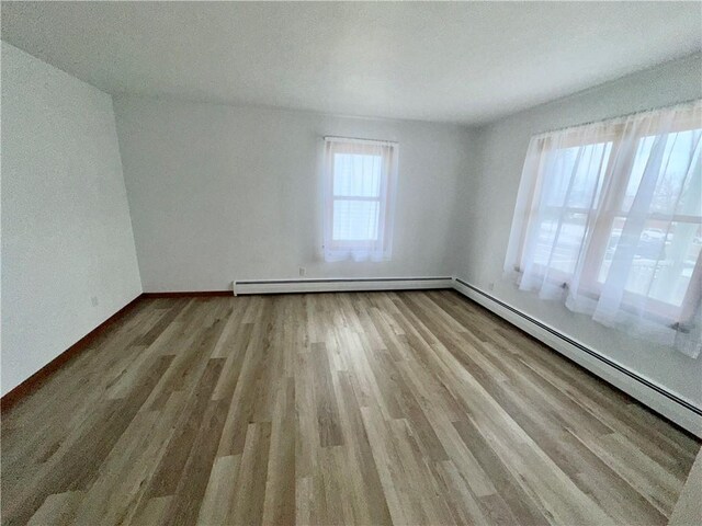 302 S Main St, Masontown, PA 15461 - spare room with baseboard heating, wood finished floors, and baseboards