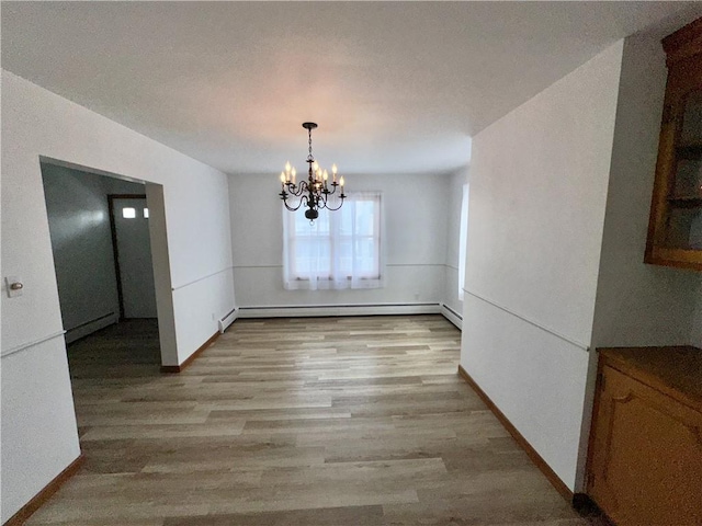 302 S Main St, Masontown, PA 15461 - unfurnished dining area featuring a baseboard radiator, light wood-style floors, a chandelier, and baseboards