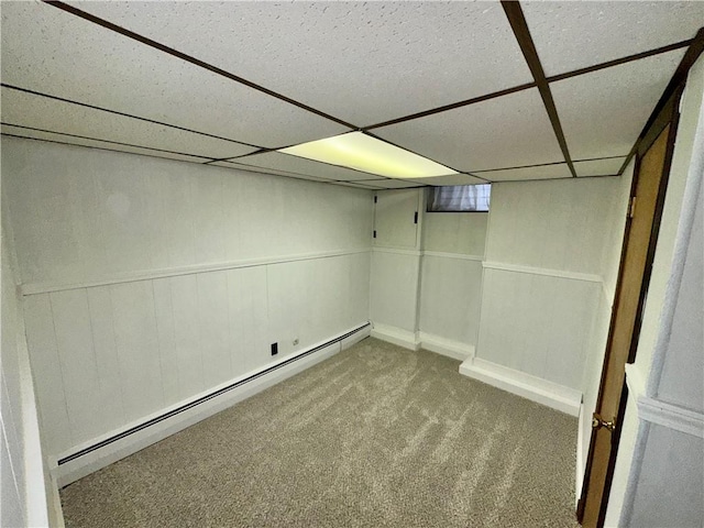 302 S Main St, Masontown, PA 15461 - finished basement with a baseboard heating unit, carpet, a drop ceiling, and a wainscoted wall