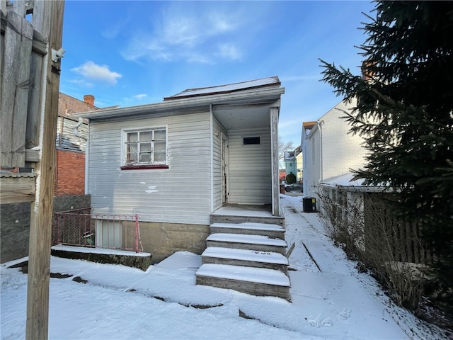 view of snow covered property entrance